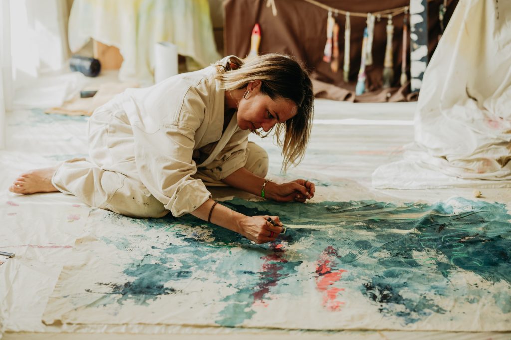 Artist in residence painting on the floor of her suite at Anfitrión Marbella