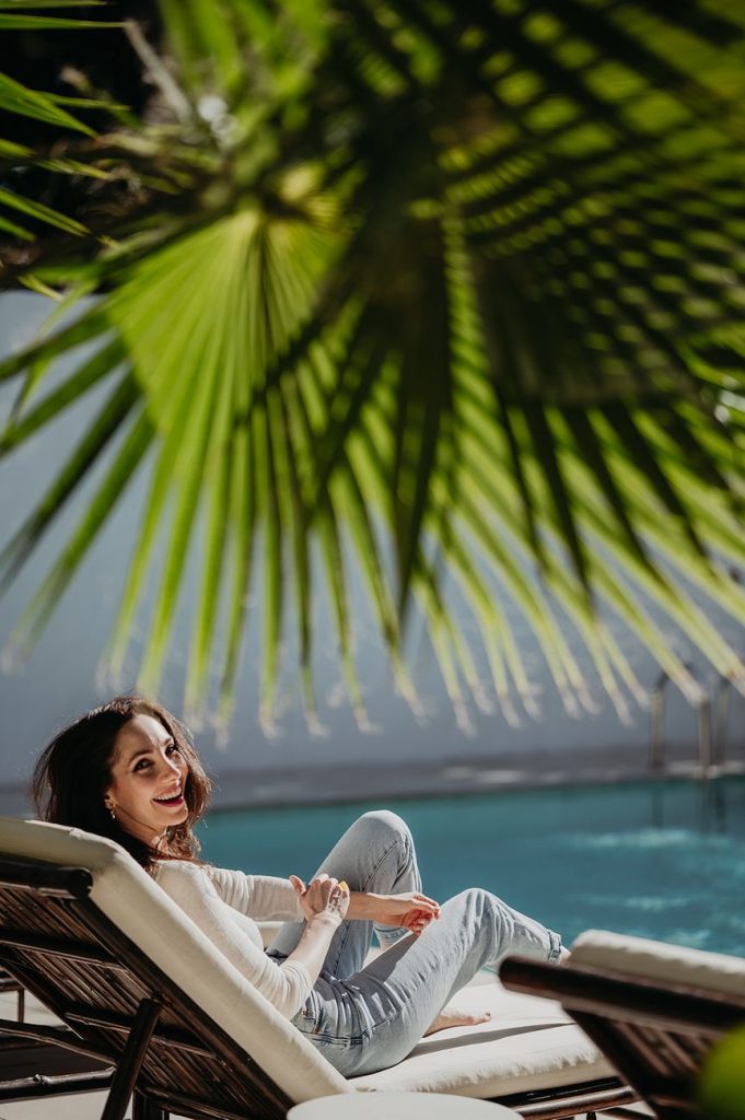 Artist in residence resting on a sun lounger by the pool at Anfitrión Marbella