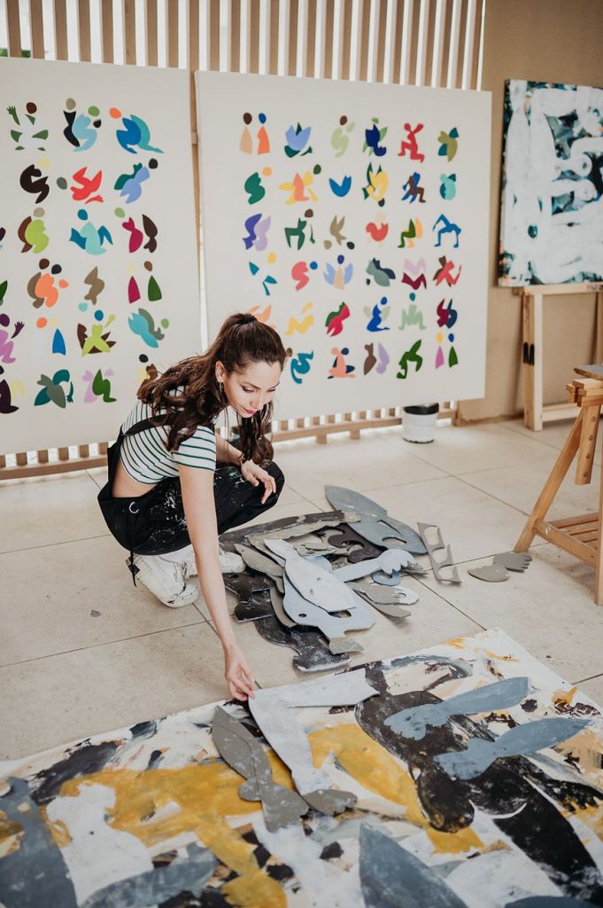 Artist working on the floor of the equipped studio at Anfitrión Marbella